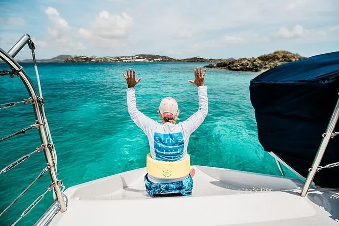 Guests snorkeling from a catamaran near a beach cay in St. John USVI before lunch at the famous floating Pizza Pi boat